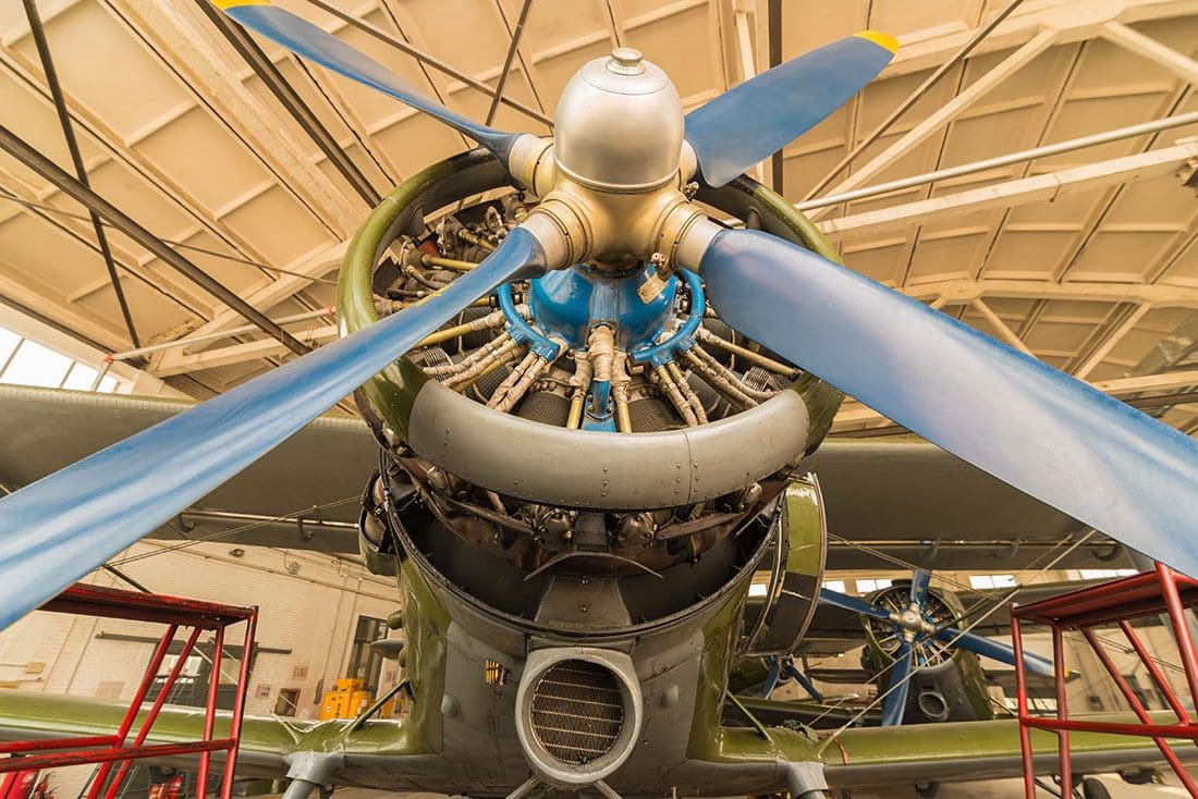 Front view of airplane engine in hangar.